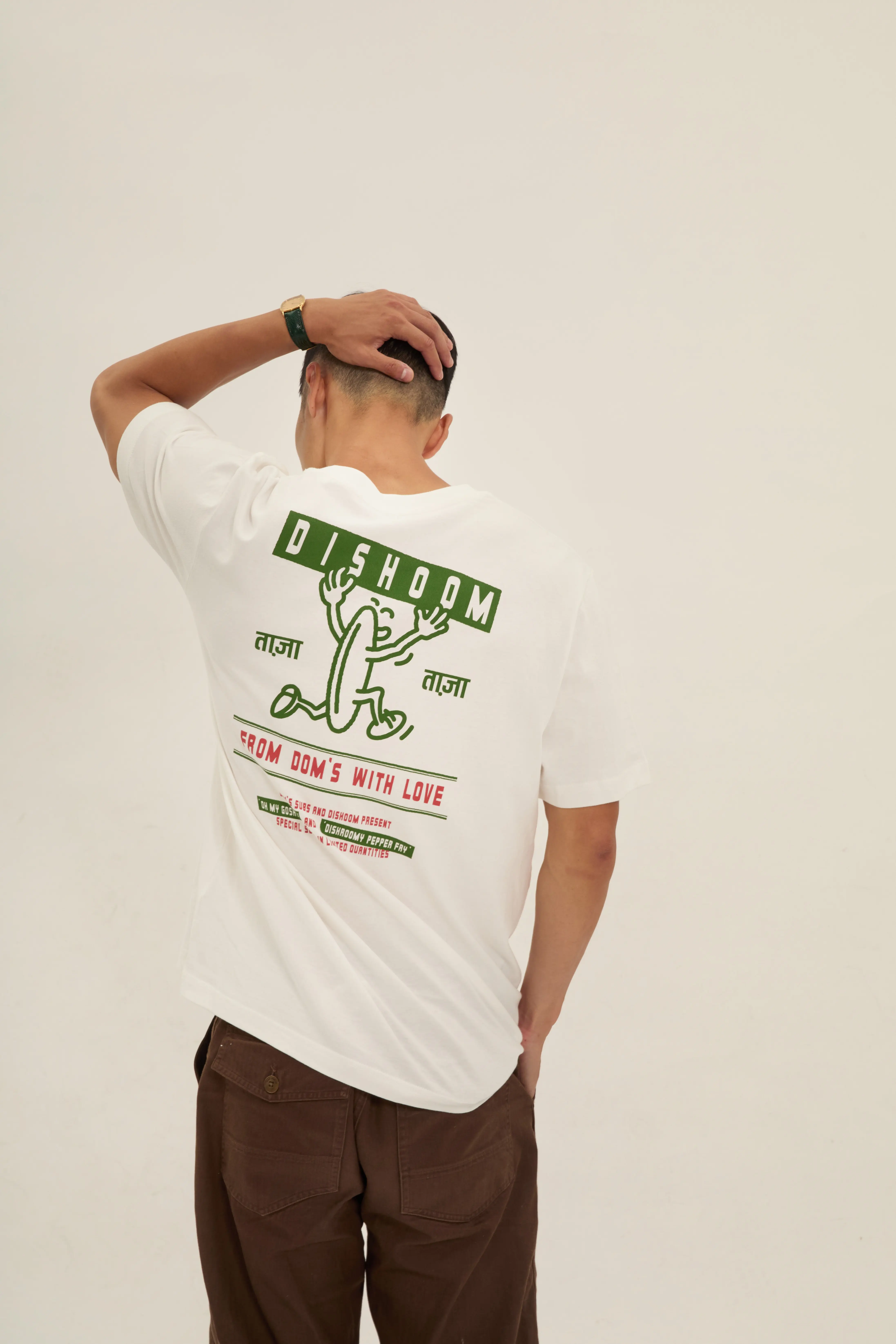 Man wearing a Dishoom-branded relaxed fit graphic t-shirt produced by Brand Stamp